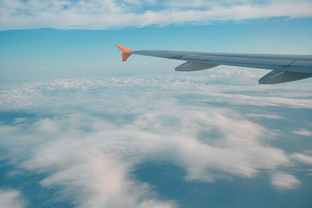istock Wings touching the clouds on a sunny day during a tranquil flight over the open sky 2240737154