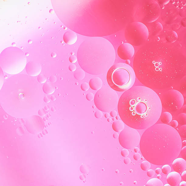 istock Abstract pink oil and water bubbles background with soft gradient light. Bright, vibrant texture ideal for cosmetics, beauty, spa, and creative design projects 2240737340