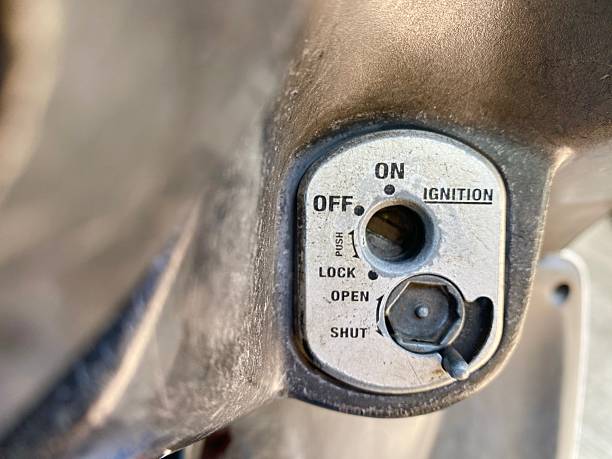 A close-up of a worn motorcycle ignition switch showing