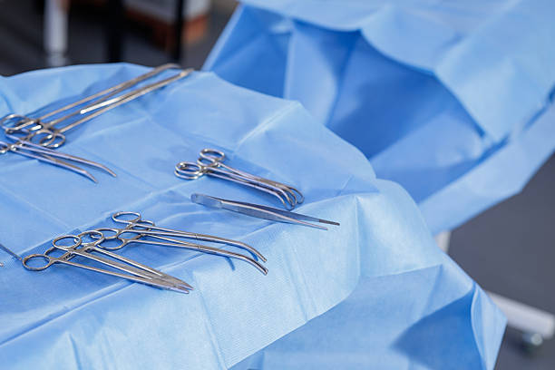 istock Sterile surgical instruments on blue drape tray in operating theatre 2240739861