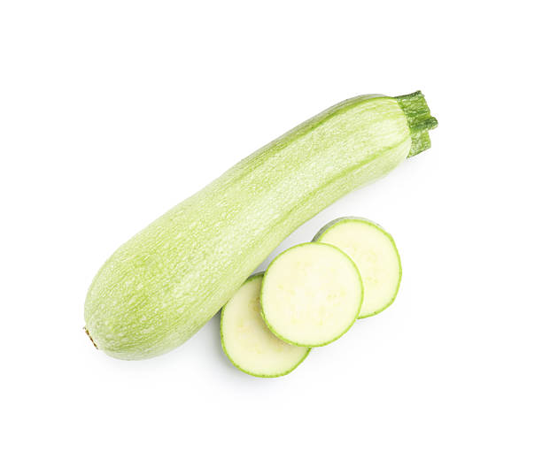 istock Fresh whole and cut zucchinis isolated on white, top view 2240740110