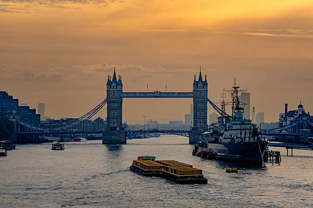 September 2025, London - Tower Bridge in the early morning light, with HMS Belfast in front.