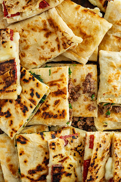 Turkish Traditional Gozleme / Pancake. Traditional Turkish flatbread or Gozleme. Breakfast. Turkish sausage Gozleme. "Gözleme or bazlama" which is a traditional Turkish stuffed flat bread. Gözleme varieties.