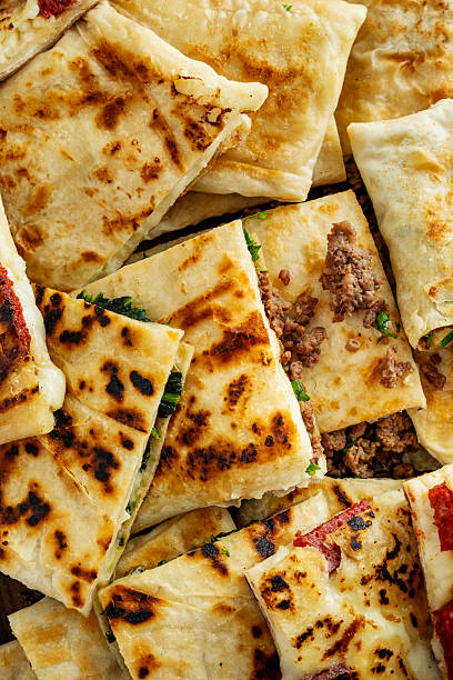 Turkish Traditional Gozleme / Pancake. Traditional Turkish flatbread or Gozleme. Breakfast. Turkish sausage Gozleme. "Gözleme or bazlama" which is a traditional Turkish stuffed flat bread. Gözleme varieties.