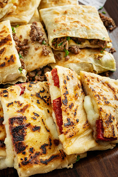 Turkish Traditional Gozleme / Pancake. Traditional Turkish flatbread or Gozleme. Breakfast. Turkish sausage Gozleme. "Gözleme or bazlama" which is a traditional Turkish stuffed flat bread. Gözleme varieties.