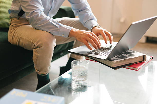 istock Close-up of man typing on laptop at modern workspace 2240743332