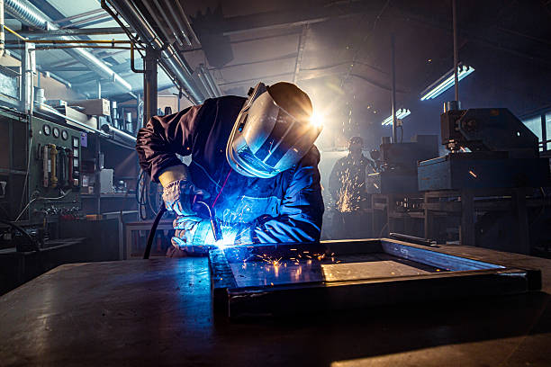 istock Industrial worker welding metal frame in factory workshop 2240744355