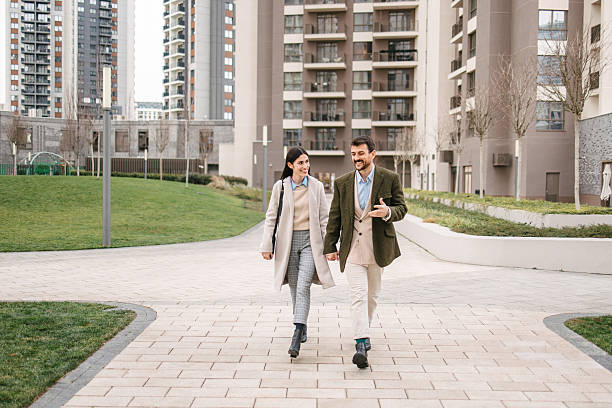 istock Modern business couple walking through residential district 2240749728
