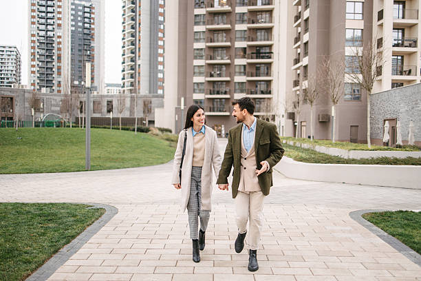 istock Young couple walking in modern residential district 2240749746