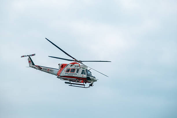 Samsun, Turkey - May 19, 2023: Turkish Coast Guard helicopter flying in a clear sky. Search and rescue White and orange coast guard command helicopter hovering over the sea