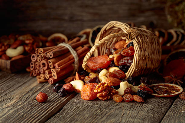 istock Dried fruits and nuts on an old wooden table. 2240750050