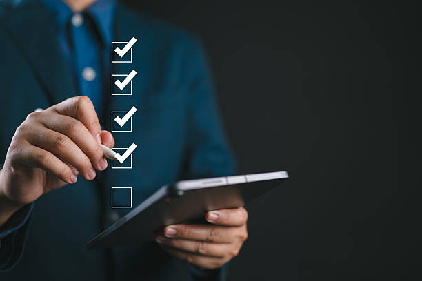 Digital Checklists for efficient business management, Businessman tick marking on checklist guide to paperless assessment and Future Success, streamlining operations with online surveys.