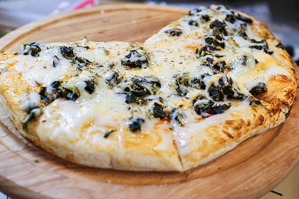 Close-up of Mushroom Pizza with Champignon and melted cheese on a wooden tray. Popular Thai street food snack.
