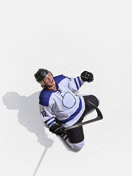 istock Top angle hockey forward in blue jersey shouting with joy after scoring 2240752289