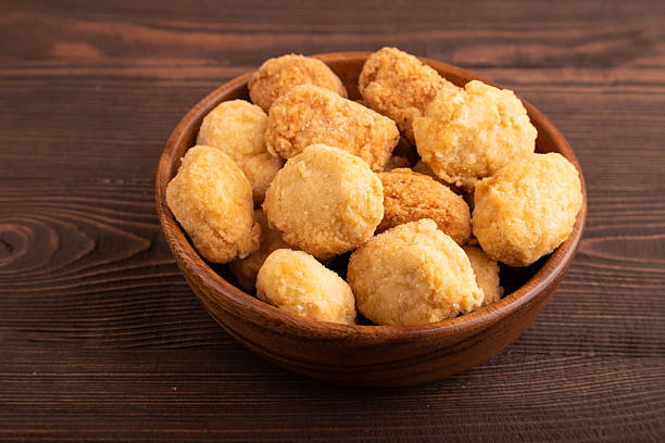 istock Fried crispy Chicken Nuggets on brown wooden. side view, close up 2240752905