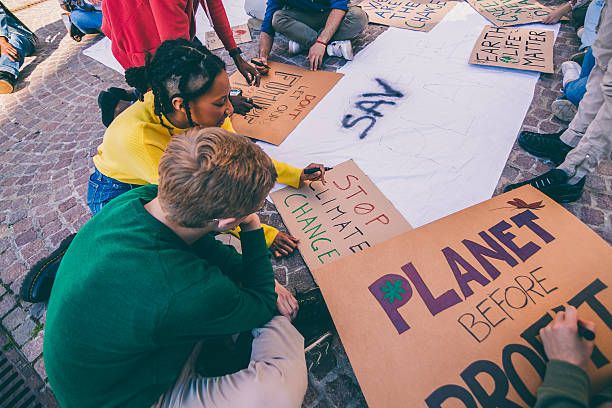 istock Youth activists preparing protest signs for climate change demonstration 2240754283