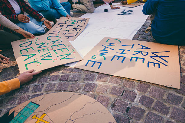 istock Activists preparing protest signs for climate change demonstration 2240754291