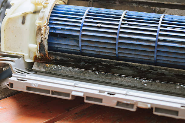 istock Professional technician servicing and cleaning a residential air conditioner 2240757135