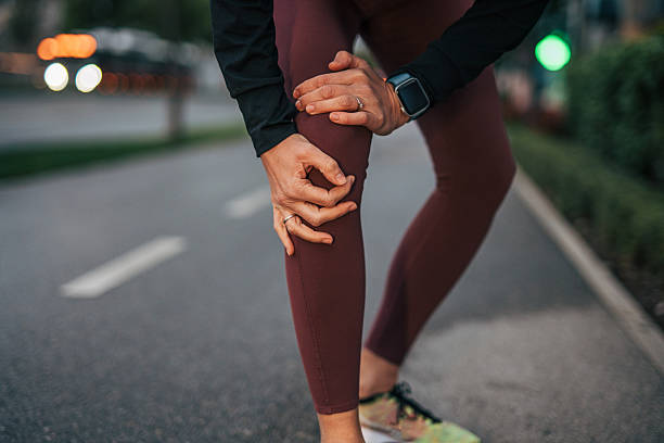 istock Woman runner feeling knee pain during outdoor workout 2240757616