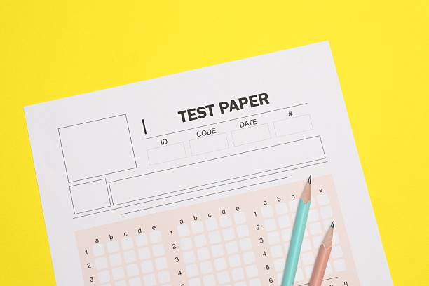 istock Answer sheet and pencils on yellow background, flat lay. Student passing exam 2240760044