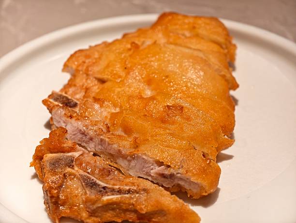 istock close up golden fried pork chop on white plate 2240761952