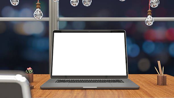 Laptop with Blank White Screen on a Desk with City Lights at Night. 3D Render