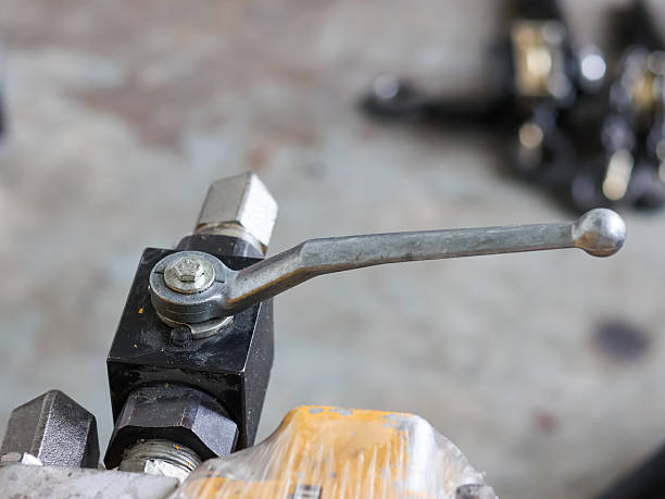 istock manual control lever on a black hydraulic valve block 2240762565