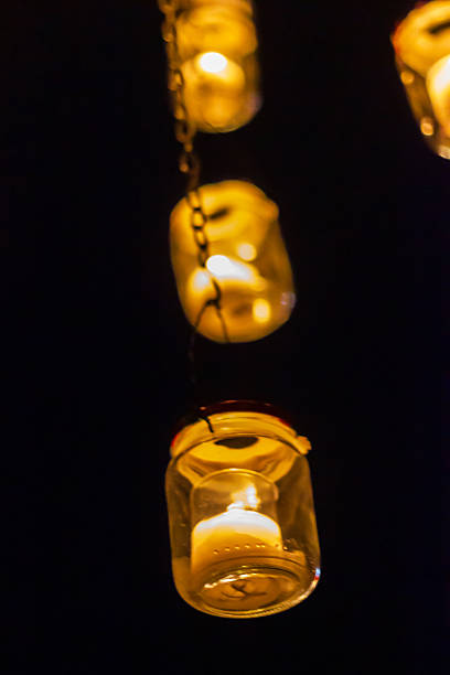 istock Warm Golden Jar Lanterns Hanging From a Chain Create Cozy Nighttime Ambiance 2240762938