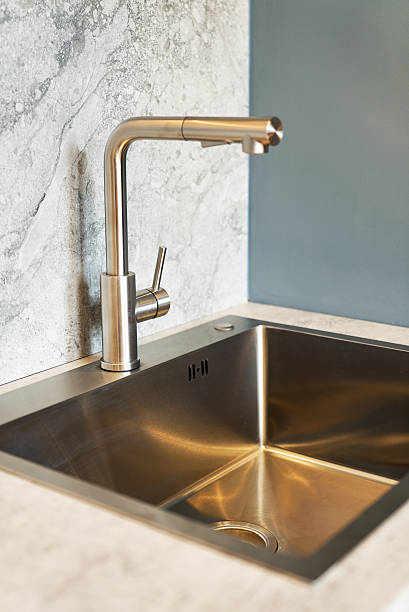 istock Stylish modern kitchen sink with a shiny faucet. 2240763016