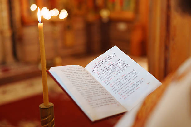 An open Bible rests on a wooden church lectern, illuminated by warm light, creating a peaceful and spiritual atmosphere in a sacred space.