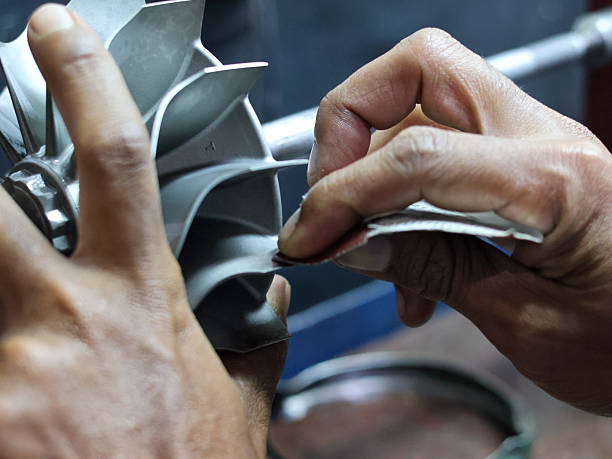 istock Close-up of a worker's hands meticulously sanding the metallic blades 2240766217