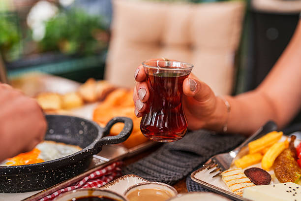 istock Hand Holding Traditional Turkish Tea Glass 2240766687