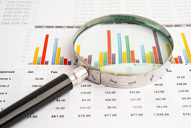 istock Magnifying glass on data business graphs paper. 2240769134