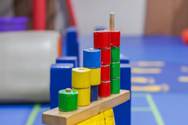 Colorful wooden educational stacking toy used for children’s learning and motor skill development in a classroom or play area.