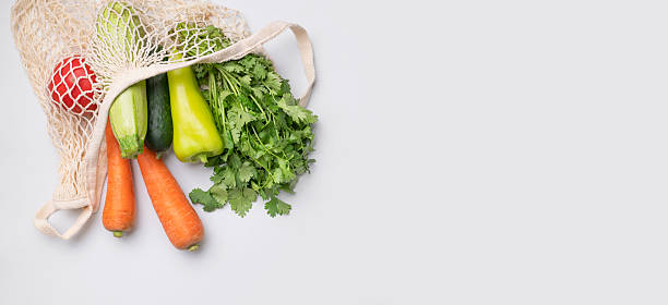 istock Various healthy organic vegetables in natural textile eco-friendly wicker string bag on gray background flat lay top view. Healthy food, seasonal products. Zero waste bag 2240774223