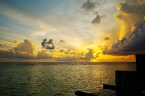 Romantic colorful sunset at the beach with waves reflection on sand on tropical island
