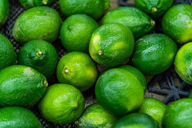 Top view of fresh green limes background full frame