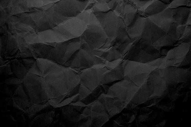 istock Dark crumpled paper background with realistic folds and shadows 2240777658