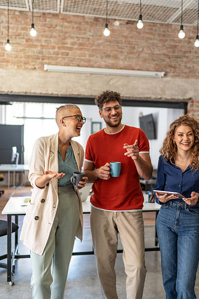 istock Diverse business colleagues having a casual laughing conversation during coffee break 2240778936