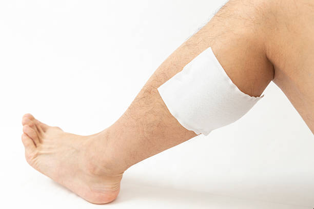 istock A man's leg with a compress on it, white background 2240779055