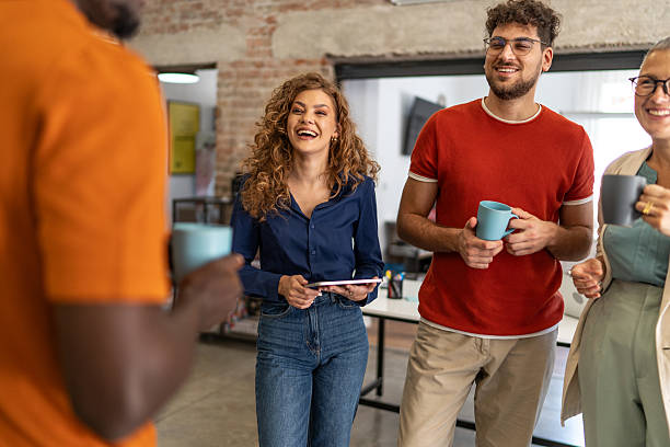 istock Diverse business team laughing during a coffee break in modern office 2240779071