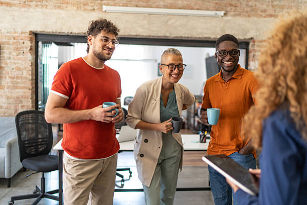 istock Diverse coworkers having coffee break and talking in modern office 2240779075