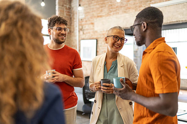 istock Diverse business team smiling and talking during coffee break 2240779843