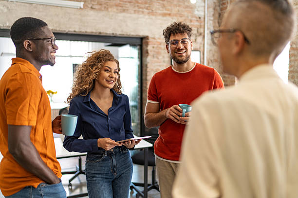 istock Diverse coworkers having coffee break office discussion 2240779953