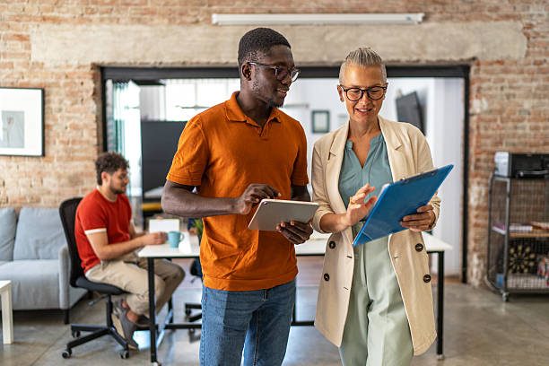 istock Business colleagues collaborating on digital tablet and clipboard 2240780572