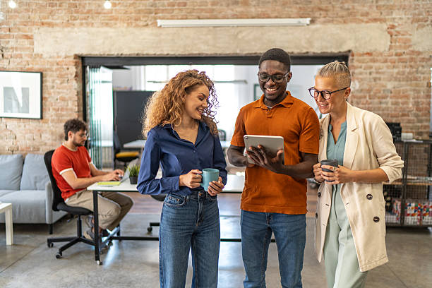 istock Diverse business people collaborating in modern office using digital tablet 2240781044