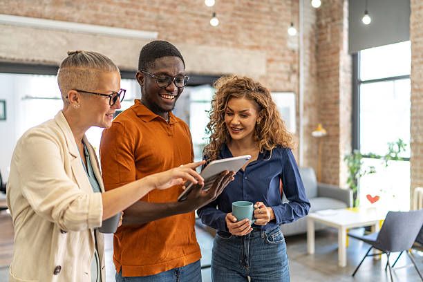 istock Diverse business colleagues using digital tablet in office 2240781050