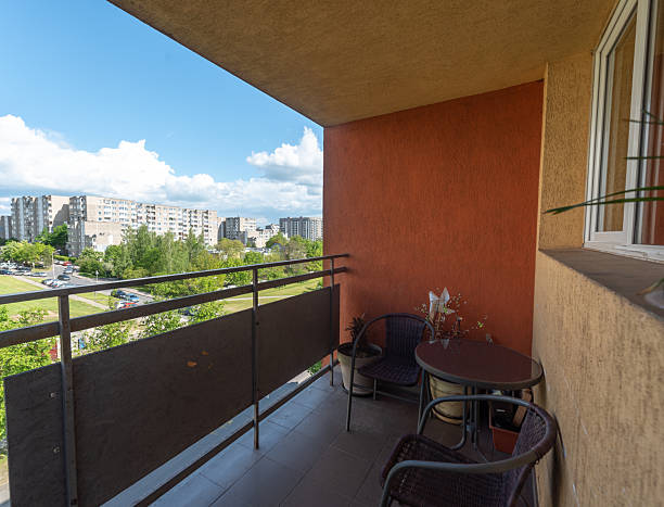 istock Cozy Apartment Balcony With Chairs Overlooking a Residential Area 2240783502