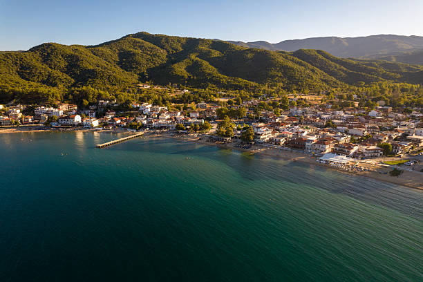 istock Coastal village with pier and beach in greece 2240783782