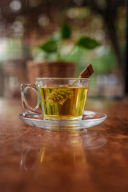 istock Cup of Herbal Green Tea Served on Wooden Table 2240785179